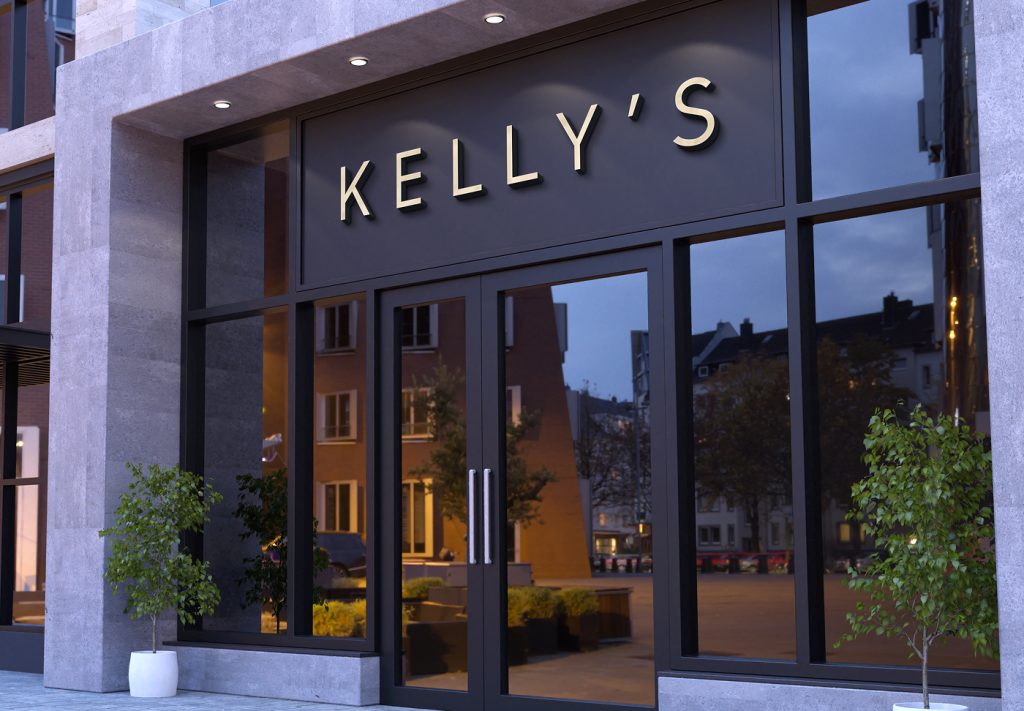 Kelly's storefront signage above glass entrance doors at dusk